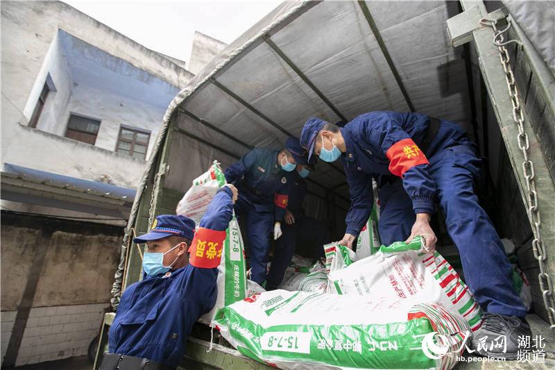 2020年3月2日，湖北省襄陽市，谷城縣經濟開發區聶家灘社區一化肥倉庫，襄陽市消防救援支隊“119黨員突擊隊”隊員將化肥產品裝車發貨。 （楊東 蘇曉杰 攝）