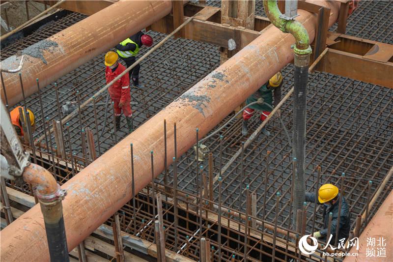 3月31日，施工人員在襄陽東西軸線魚梁洲隧道東津出口進行混凝土澆筑。（楊東 攝）