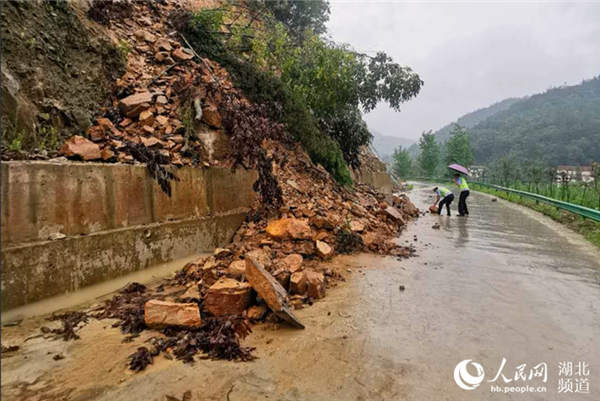 交警冒雨清理山體塌方物