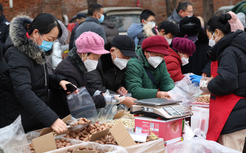 1月10日，在湖北省襄阳市襄城区迎新春年货节上，市民在挑选干果。