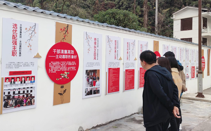白果乡龙潭坝村委会广场村民们在清廉文化长廊前驻足观看。