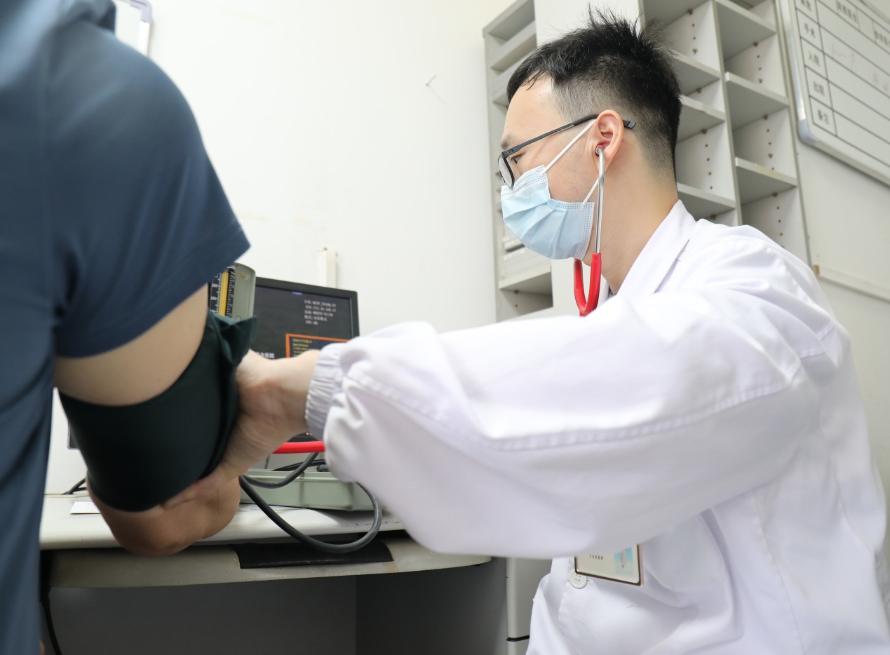 武汉市第一医院心血管内科病区，易春风医生为患者测量血压 通讯员代雨朦