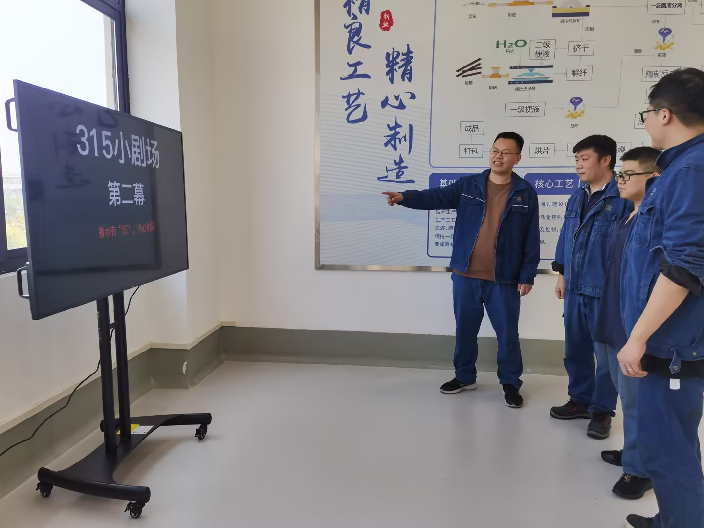 新业薄片公司车间职工驻足观看3.15普法小剧场。闵杨摄