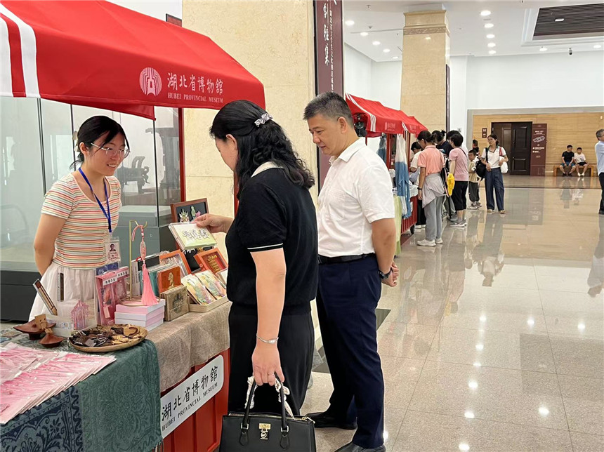 “字绘中国”团队学生向游客介绍文创产品