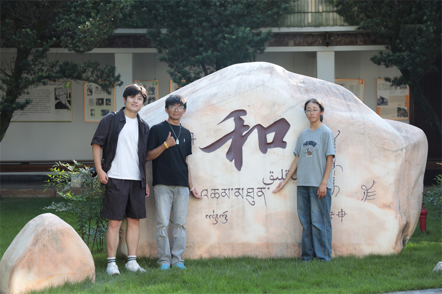 博物馆内文化石前合影。学校供图