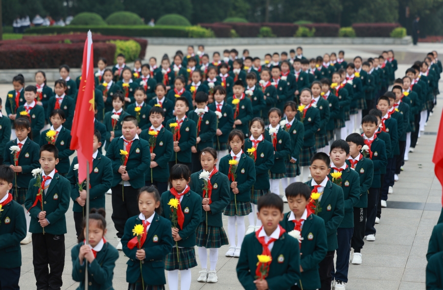 少先隊員在烈士紀念碑前默哀。人民網記者 張雋攝