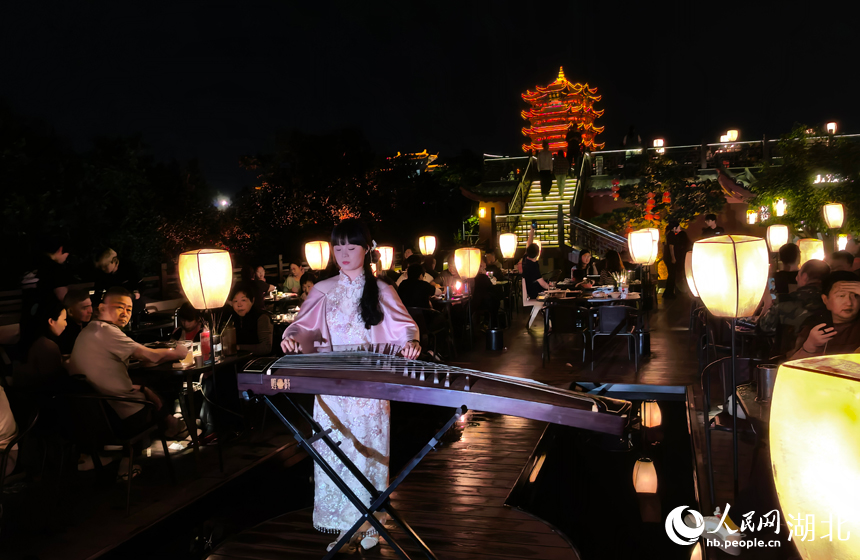 夜幕下的黃鶴樓燈火璀璨，周邊天台餐飲人氣火熱，市民游客沉浸式賞樓就餐。
