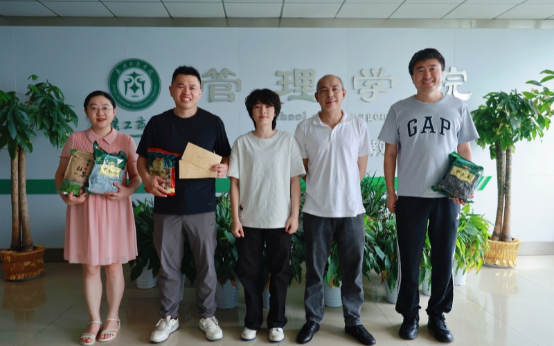 都虹宇（中）、都虹宇父亲（右二）与学院老师合影。芮雨欣摄