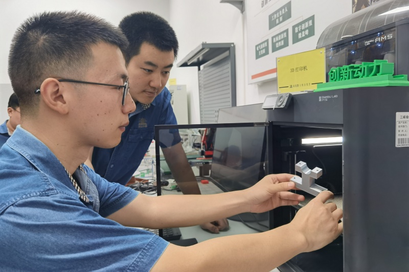 湖北中烟三峡卷烟厂青年数字创客运用3D技术打印配件。陈辉摄