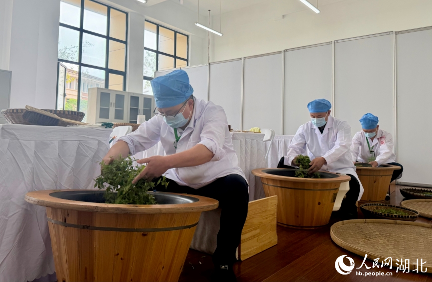 茶叶加工项目，选手熟练翻炒鲜叶。人民网记者 张沛摄