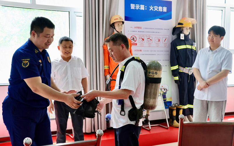 干部职工到在消防救援大队实地练习灭火设备。